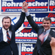 Oliver North, the former Marine lieutenant colonel who faces federal conspiracy charges for his role in the Iran-Contra affair, joins old White House buddy Dana Rohrabacher, candidate for the state's 42nd Congressional District, at a rally in a hangar at Long Beach, California Airport, June 1, 1988.
